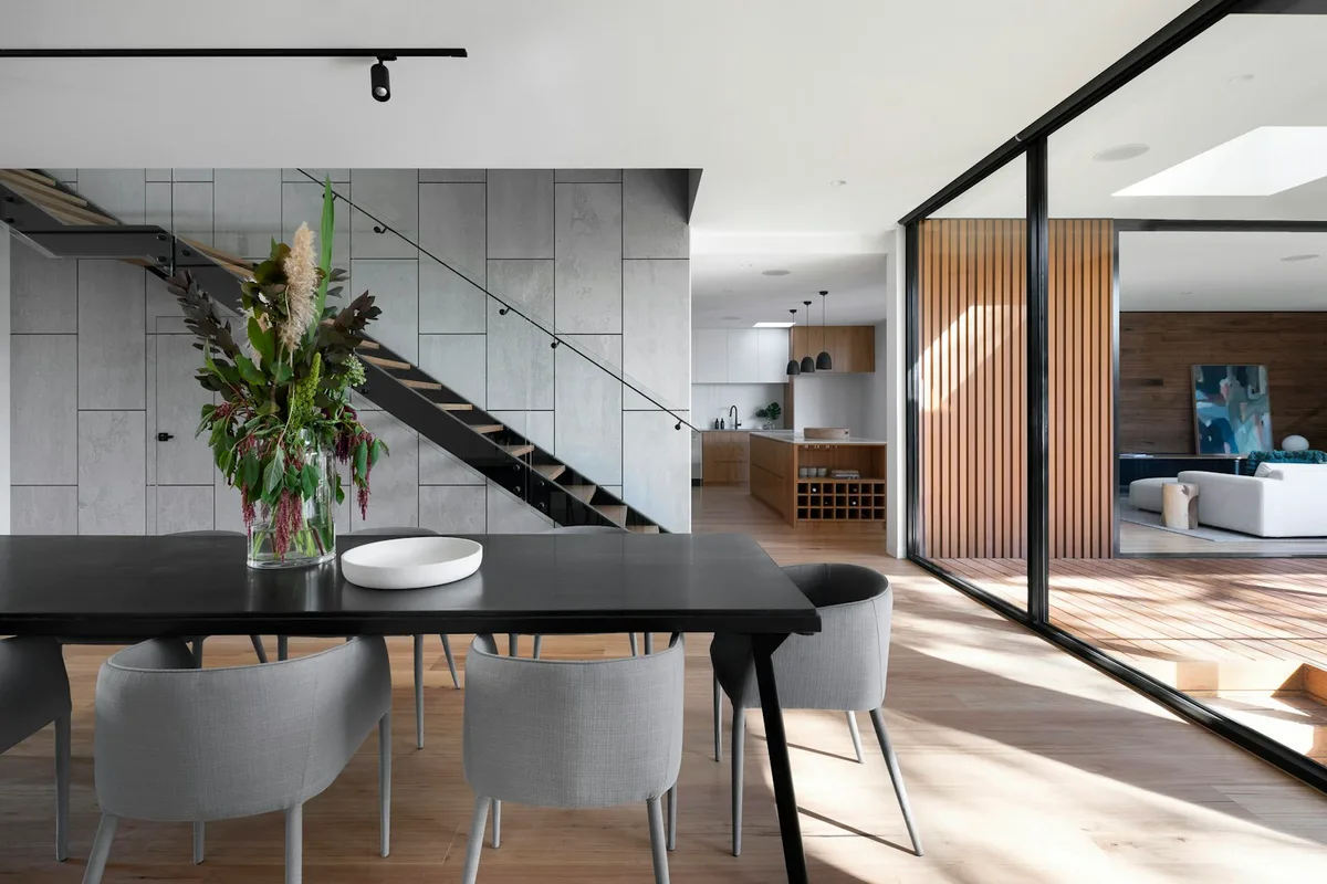 An architectural dining space opening onto adjoining living areas
